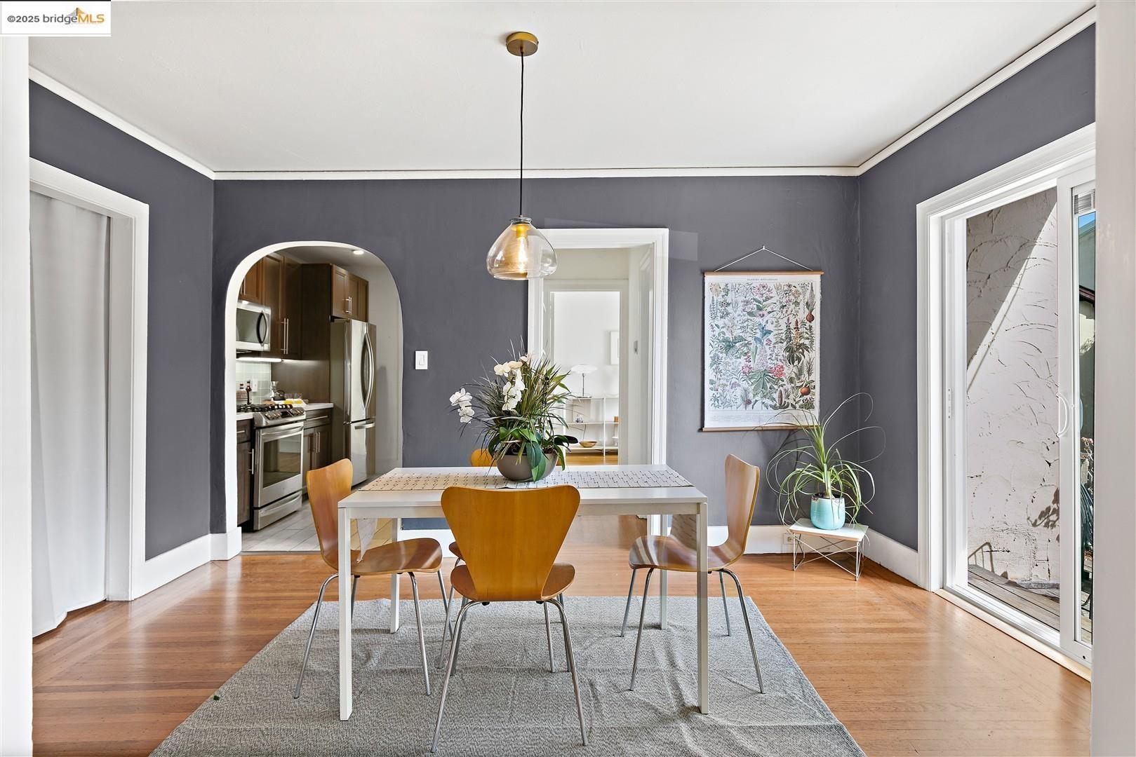 2201-2203 Spaulding Avenue Berkeley, CA 94703 - Photo 11 of 56 Dining room featuring arched walkways, light wood finished floors, and ornamental molding