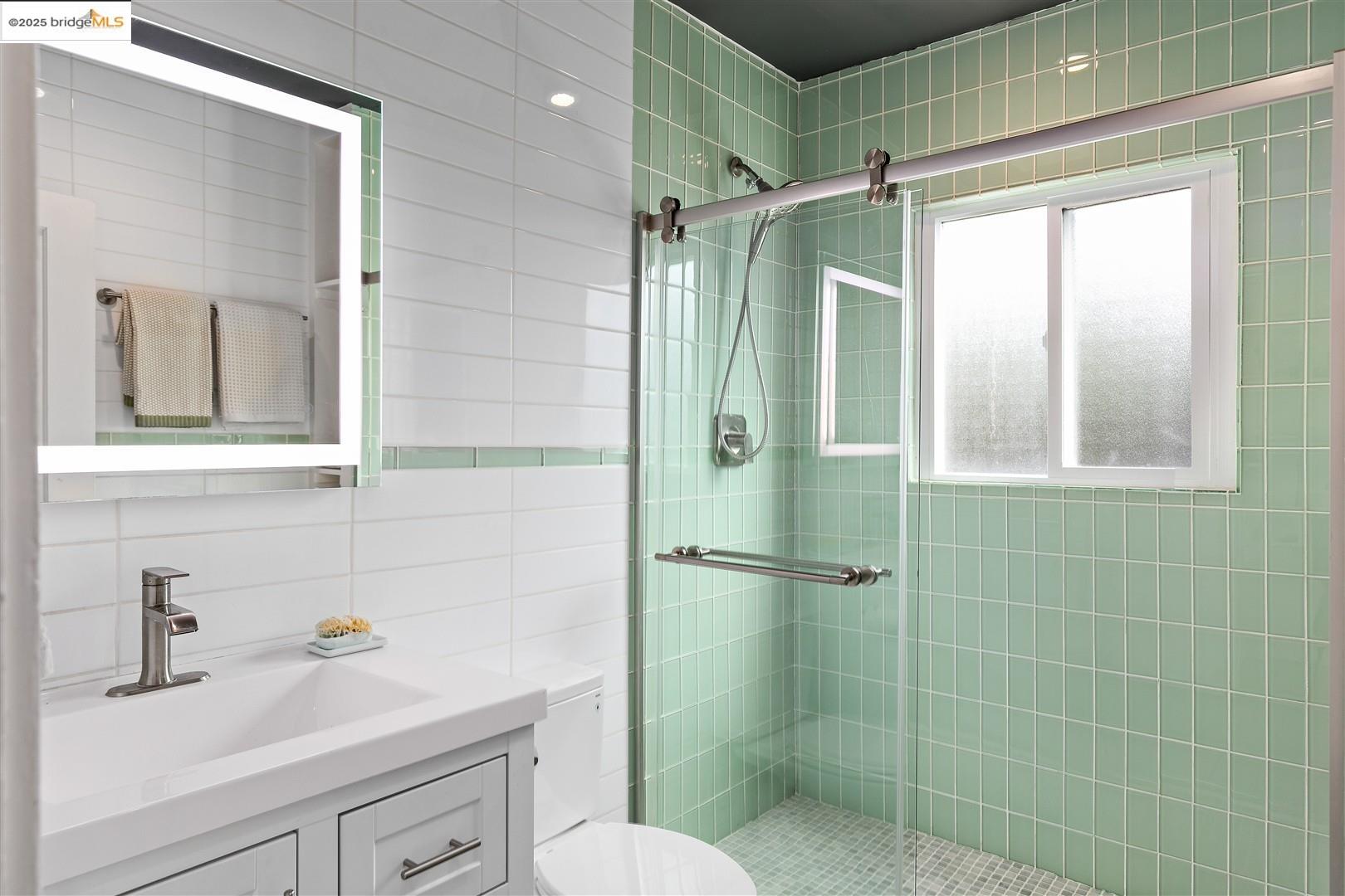 2201-2203 Spaulding Avenue Berkeley, CA 94703 - Photo 19 of 56 Bathroom with tile walls, a stall shower, vanity, and tasteful backsplash