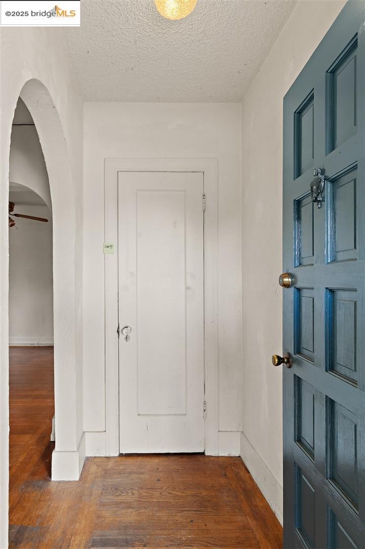 2201-2203 Spaulding Avenue Berkeley, CA 94703 - Photo 33 of 56 Foyer entrance with dark wood-type flooring, arched walkways, a ceiling fan, and a textured ceiling