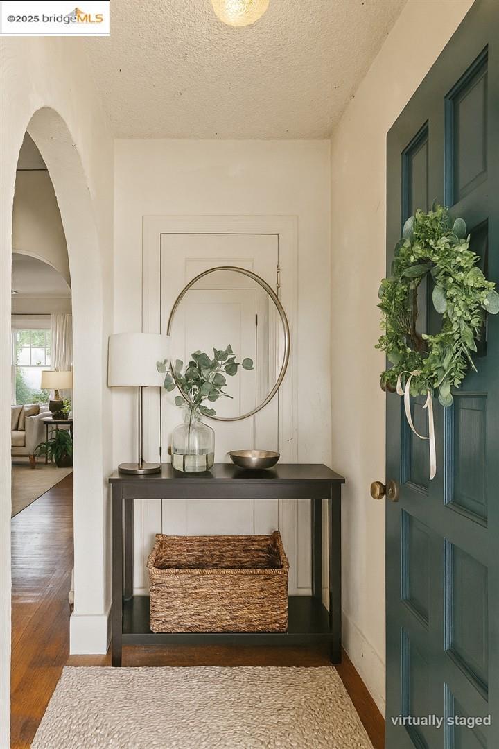 2201-2203 Spaulding Avenue Berkeley, CA 94703 - Photo 34 of 56 Hallway featuring arched walkways, a textured ceiling, and wood finished floors