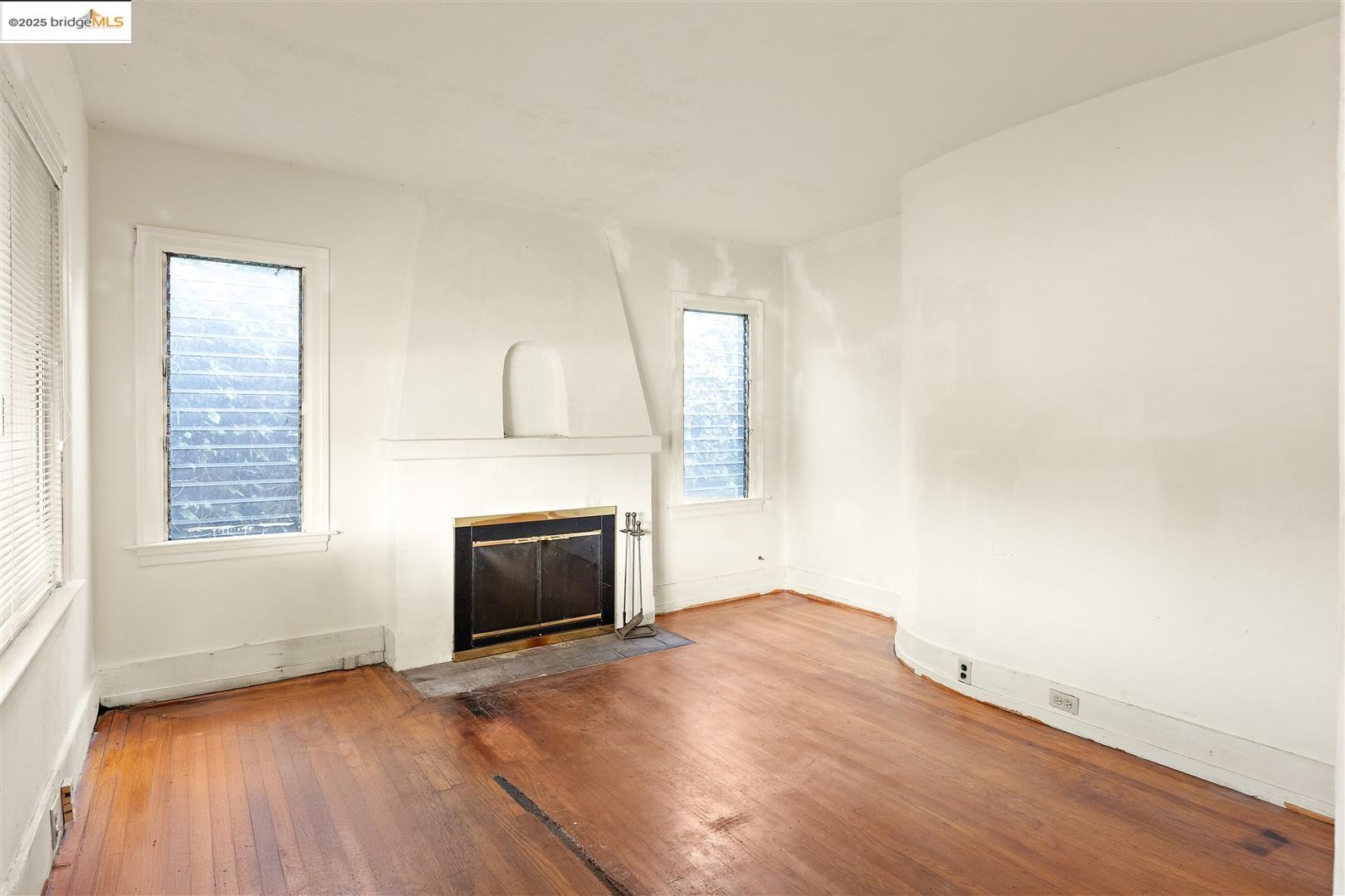 2201-2203 Spaulding Avenue Berkeley, CA 94703 - Photo 35 of 56 Unfurnished living room featuring a fireplace and wood-type flooring