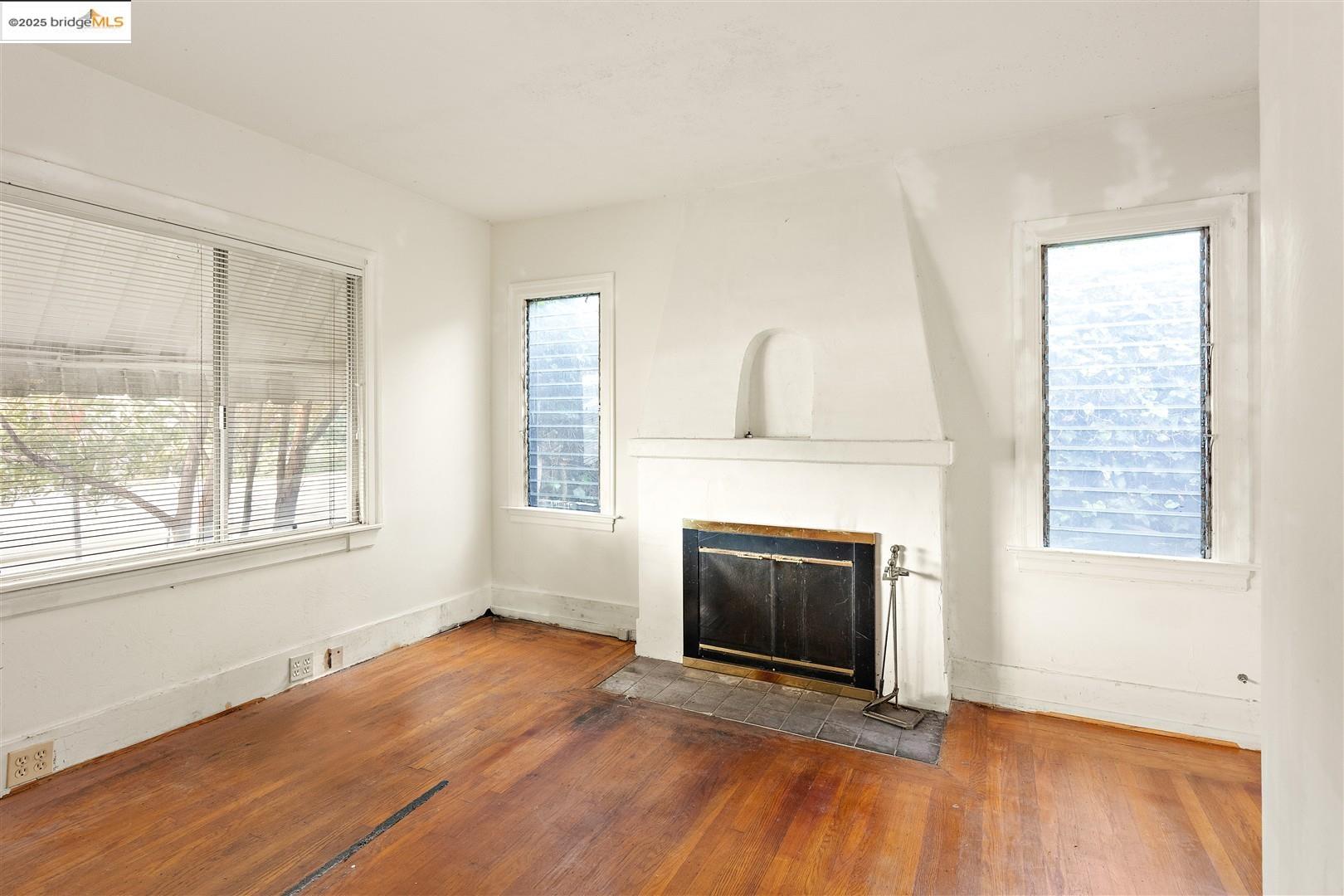 2201-2203 Spaulding Avenue Berkeley, CA 94703 - Photo 37 of 56 Unfurnished living room featuring a fireplace and hardwood / wood-style floors