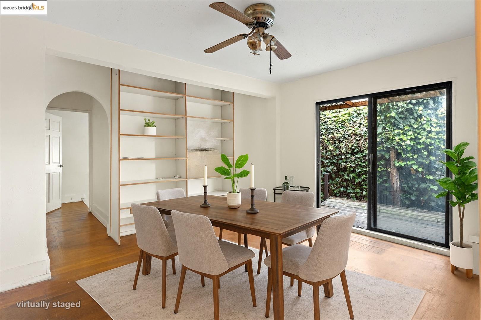 2201-2203 Spaulding Avenue Berkeley, CA 94703 - Photo 42 of 56 Dining area featuring arched walkways, built in shelves, wood finished floors, and a ceiling fan
