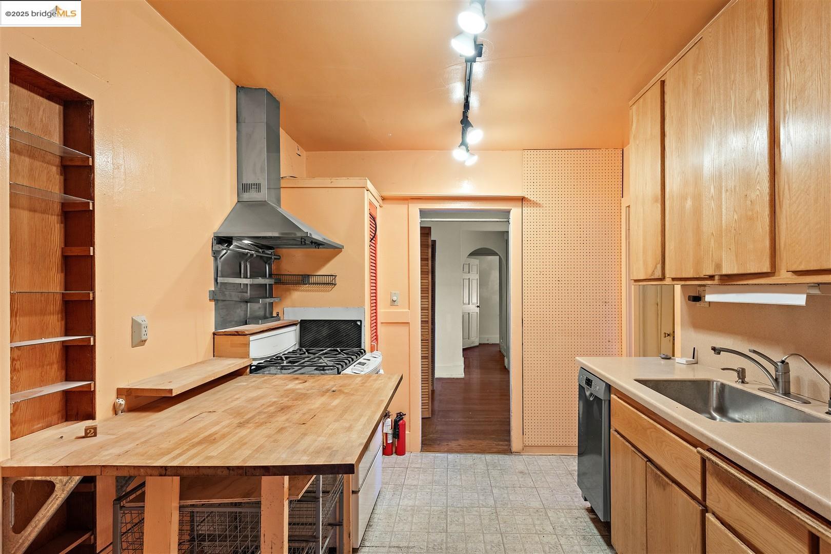 2201-2203 Spaulding Avenue Berkeley, CA 94703 - Photo 47 of 56 Kitchen with arched walkways, track lighting, extractor fan, light countertops, and dishwasher