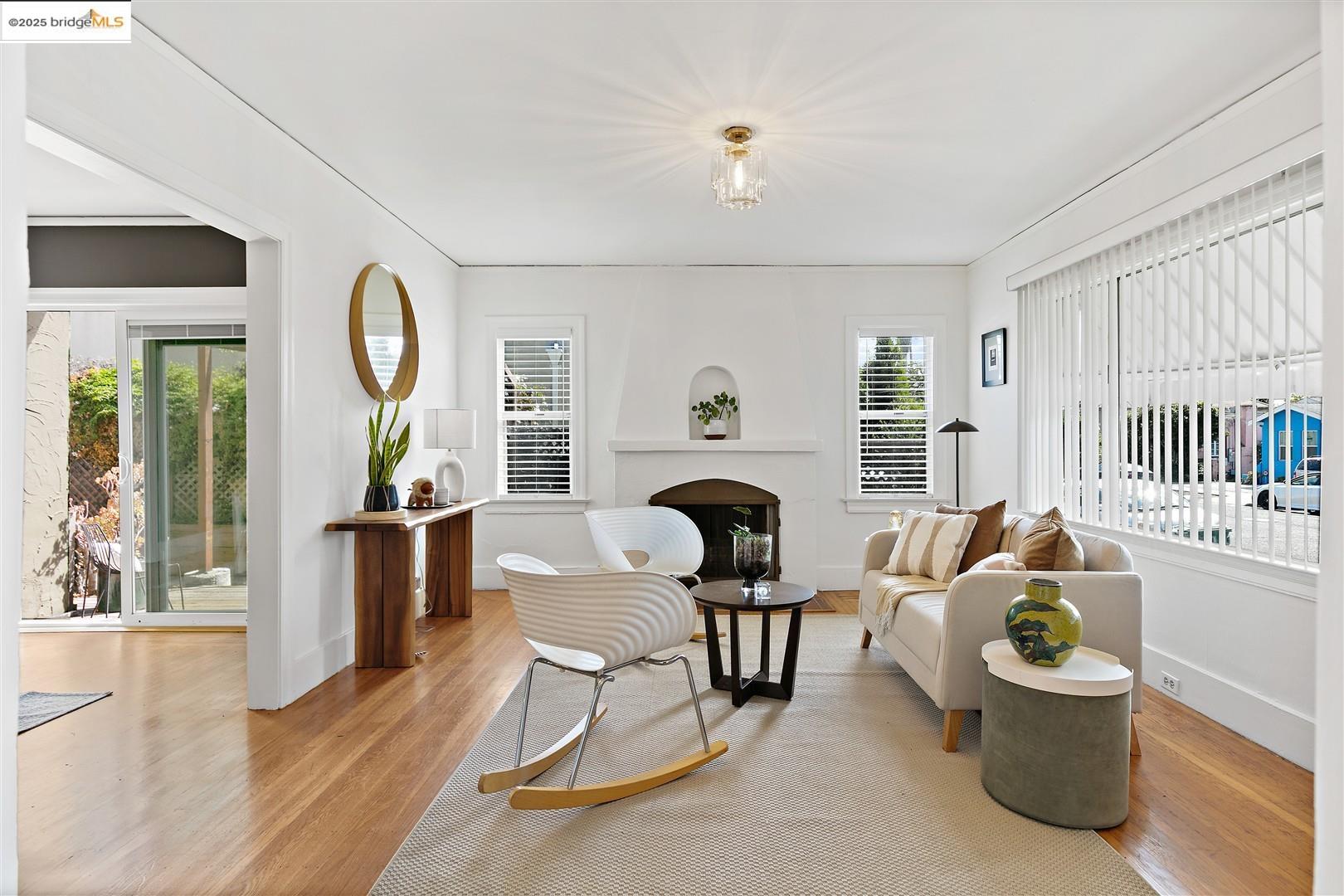 2201-2203 Spaulding Avenue Berkeley, CA 94703 - Photo 7 of 56 Living area with wood finished floors, a fireplace, and healthy amount of natural light