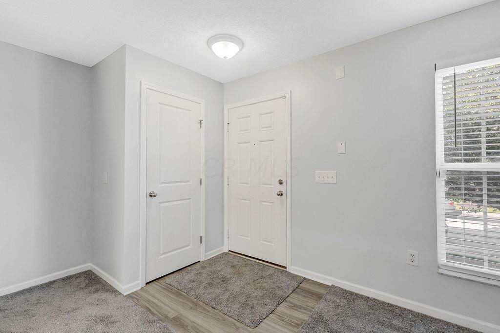6345 Needletail Road, Unit 24634 Columbus, OH 43230 - Photo 2 of 58 • New luxury vinyl plank flooring ~ 2021 • Gray painted walls • Ceiling light • Coat closet • Open to Great Room