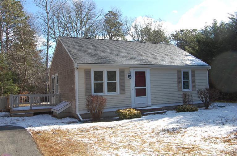 142 Skunknet Road Centerville, MA 02632 - Photo 1 of 35 a view of a house with yard fire pit and chairs in front of it