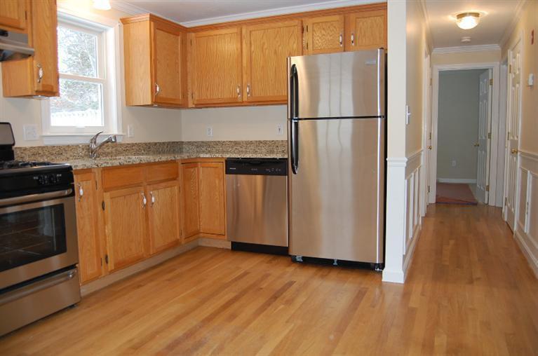 142 Skunknet Road Centerville, MA 02632 - Photo 2 of 35 a kitchen with granite countertop stainless steel appliances a refrigerator a stove a microwave and cabinets