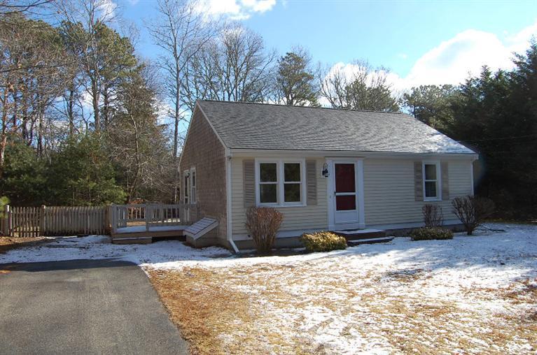 142 Skunknet Road Centerville, MA 02632 - Photo 31 of 35 a front view of a house with a yard and potted plants