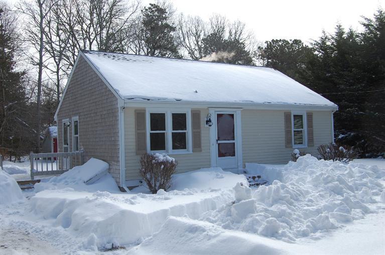 142 Skunknet Road Centerville, MA 02632 - Photo 34 of 35 a view of a house with a yard covered in snow