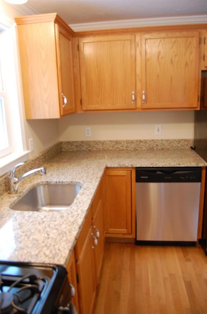 142 Skunknet Road Centerville, MA 02632 - Photo 4 of 35 a kitchen with a sink cabinets and a wooden floor