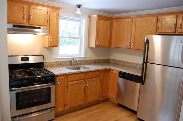 142 Skunknet Road Centerville, MA 02632 - Photo 10 of 35 a kitchen with stainless steel appliances granite countertop white cabinets a stove a sink and a refrigerator