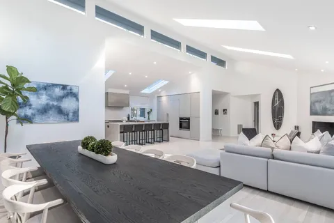 a living room with furniture kitchen view and a table