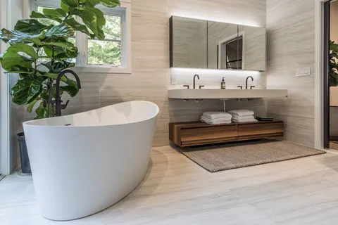 a living room with a couch and a potted plant