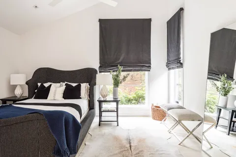 a bed room with a bed and a television