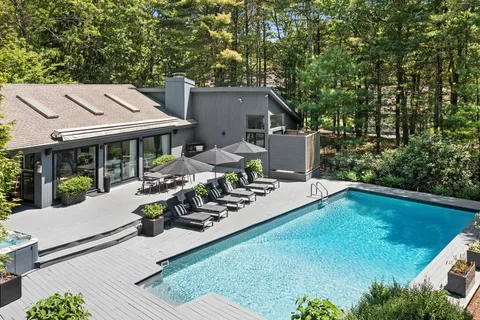 a view of a house with backyard sitting area and garden