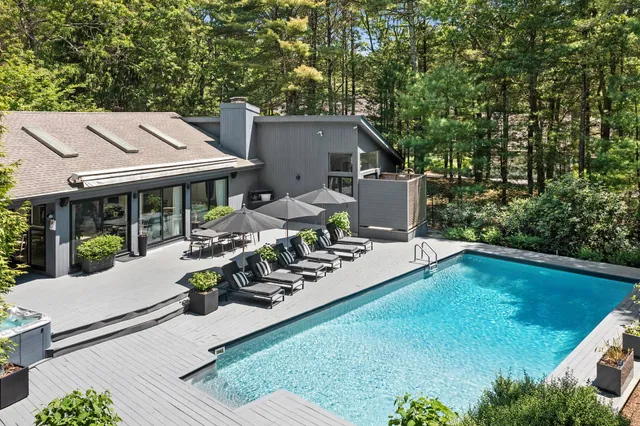 a view of a house with backyard sitting area and garden