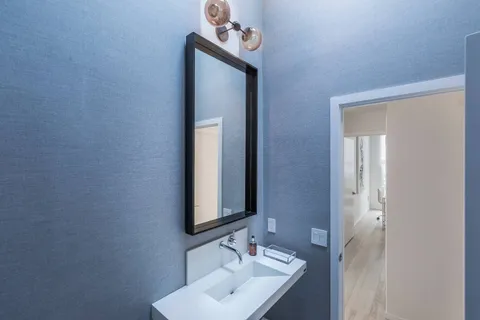 a bathroom with a sink a mirror and a vanity