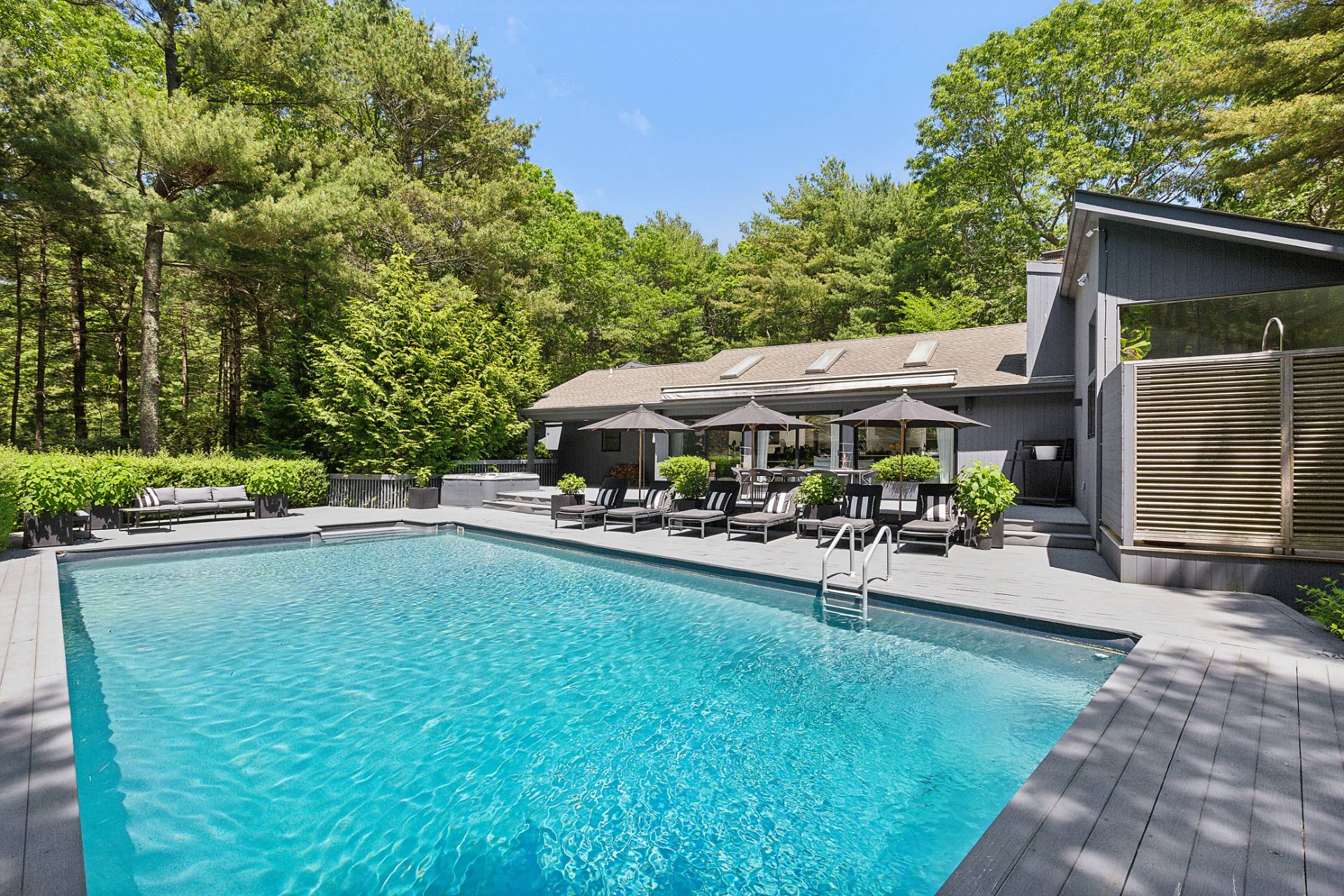 4 Bull Path Close East Hampton, NY 11937 - Photo 34 of 38 a view of a patio with table and chairs under an umbrella