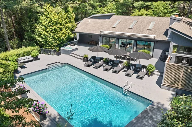 an aerial view of a house with garden space and street view