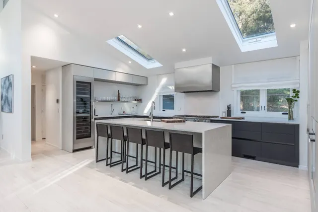 a kitchen with a sink and chairs
