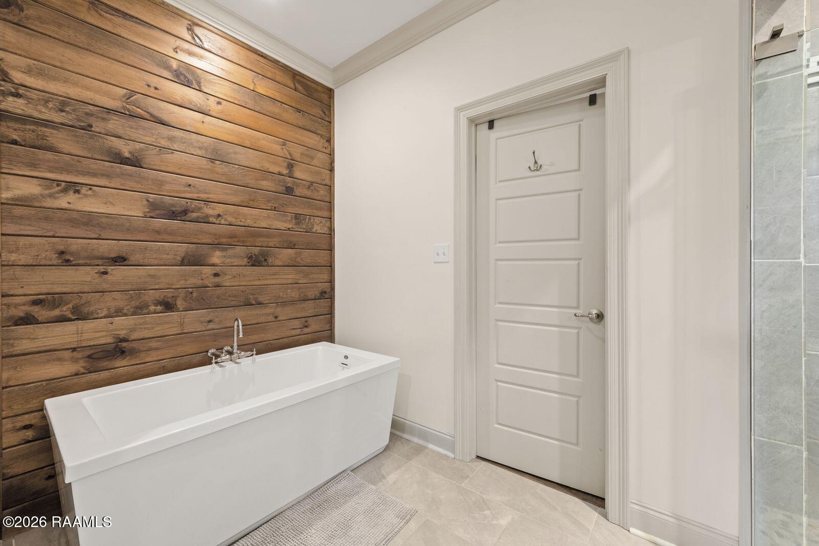 113 Rue Village Maurice, LA 70555 - Photo 23 of 34 Soaker tub with wood accent wall