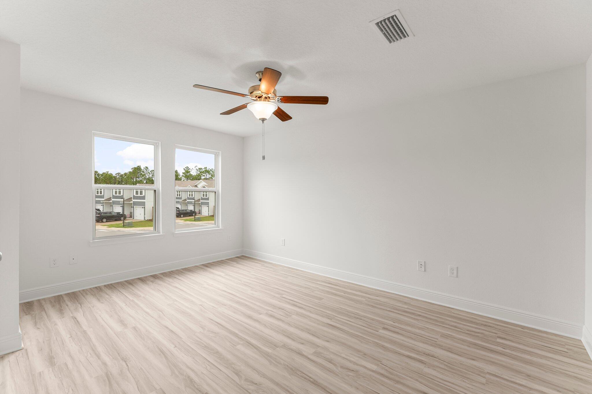 48 Hawk Street Santa Rosa Beach, FL 32459 - Photo 21 of 34 an empty room with wooden floor fan and windows
