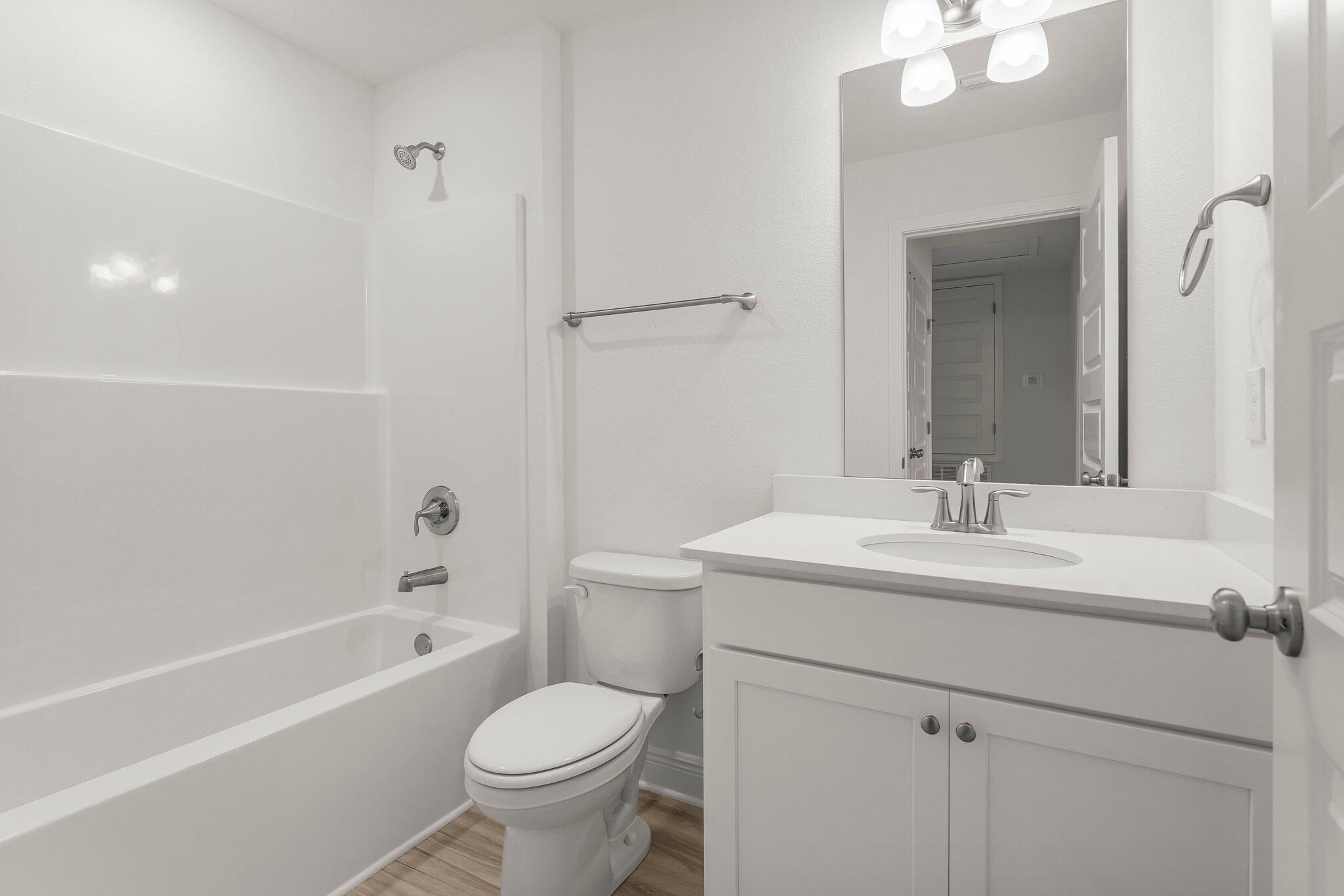 48 Hawk Street Santa Rosa Beach, FL 32459 - Photo 27 of 34 a bathroom with a toilet a sink a mirror a bathtub and vanity