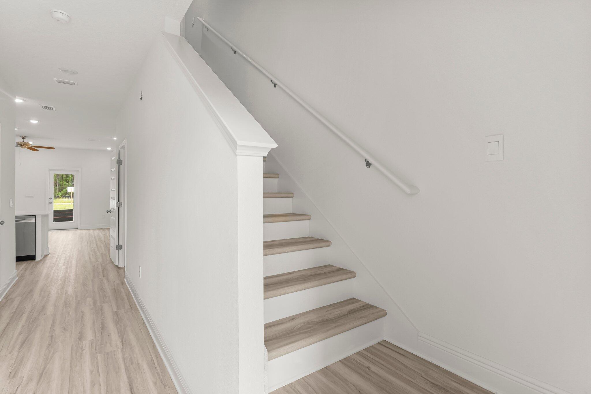 48 Hawk Street Santa Rosa Beach, FL 32459 - Photo 9 of 34 a view of a hallway with wooden floor and staircase