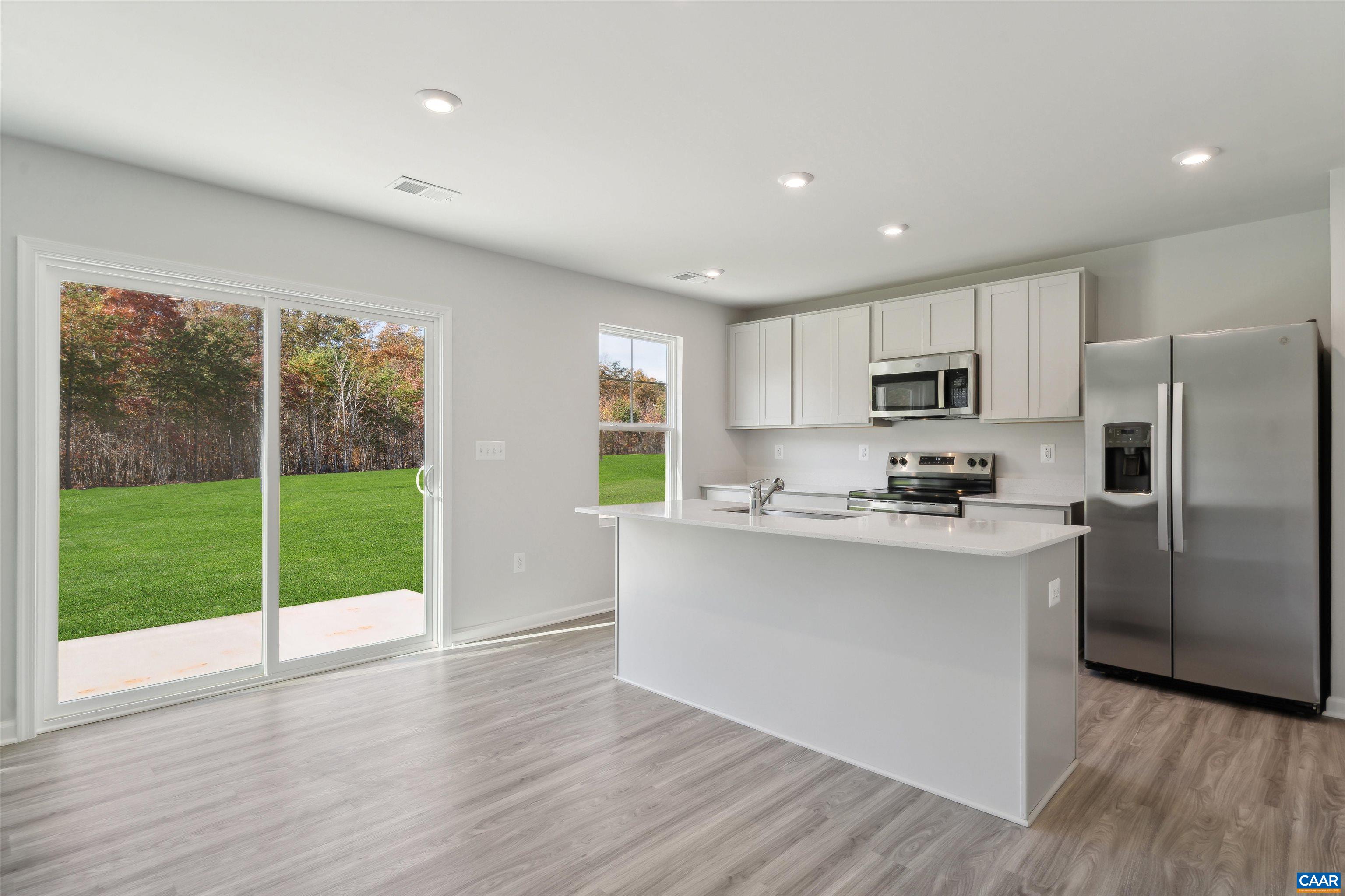 348 Trailfork Road Barboursville, VA 22923 - Photo 5 of 40 a kitchen with kitchen island wooden cabinets stainless steel appliances and a large window