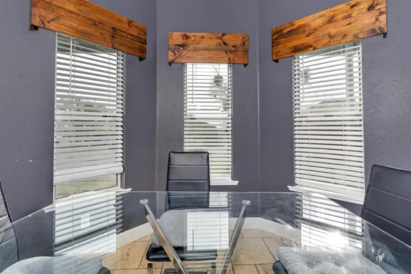 a view of a brick house with a yard and plants