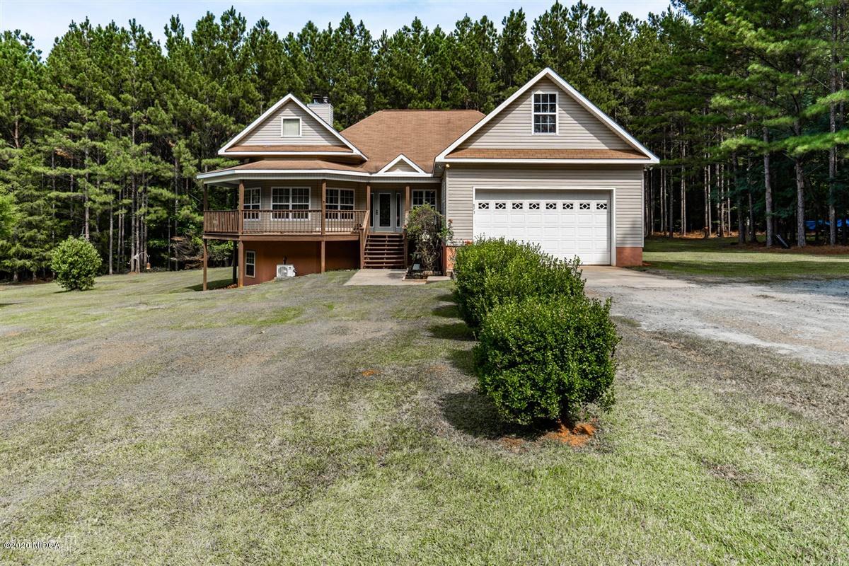 873 Blue Store Road Forsyth, GA 31029 - Photo 1 of 25 a front view of a house with a garden and trees