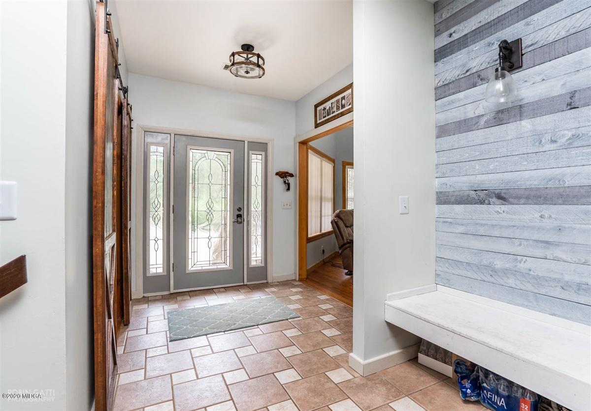 873 Blue Store Road Forsyth, GA 31029 - Photo 14 of 25 a view of a hallway with wooden floor and a bathroom