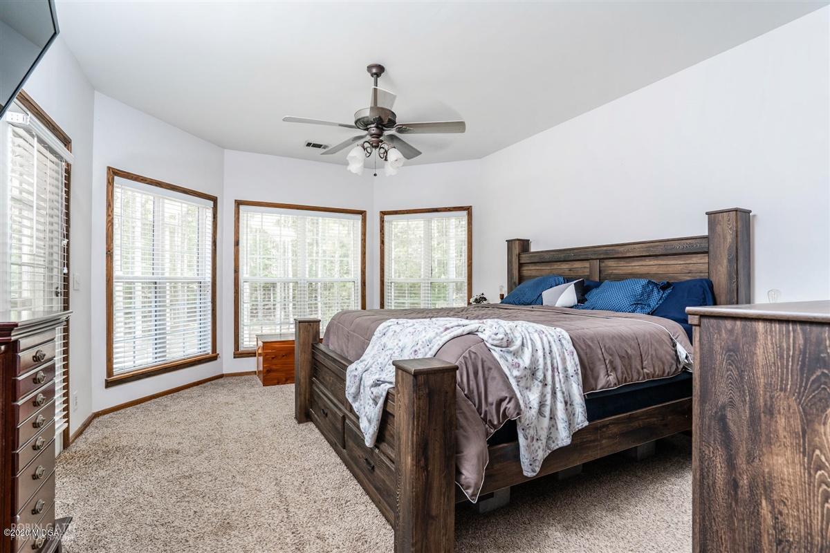 873 Blue Store Road Forsyth, GA 31029 - Photo 16 of 25 a bed sitting in a spacious bedroom next to a window