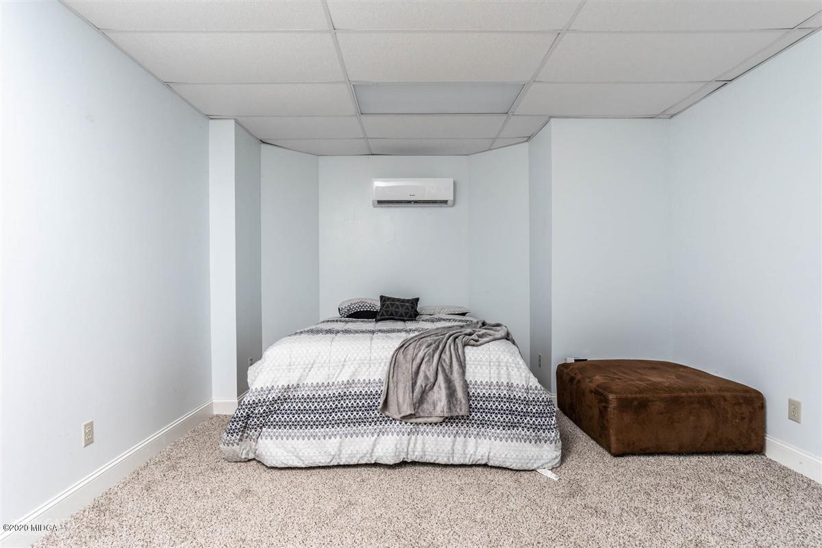 873 Blue Store Road Forsyth, GA 31029 - Photo 18 of 25 a bedroom with a bed and a couch