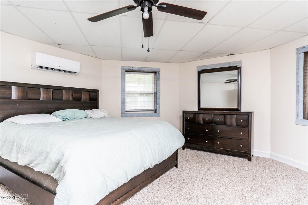 873 Blue Store Road Forsyth, GA 31029 - Photo 19 of 25 a bedroom with a bed window and dresser
