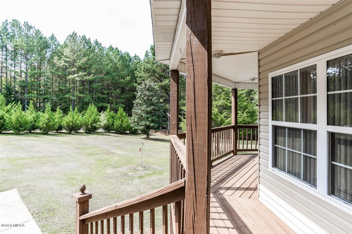 873 Blue Store Road Forsyth, GA 31029 - Photo 21 of 25 a view of a balcony with a floor to ceiling window and wooden floor