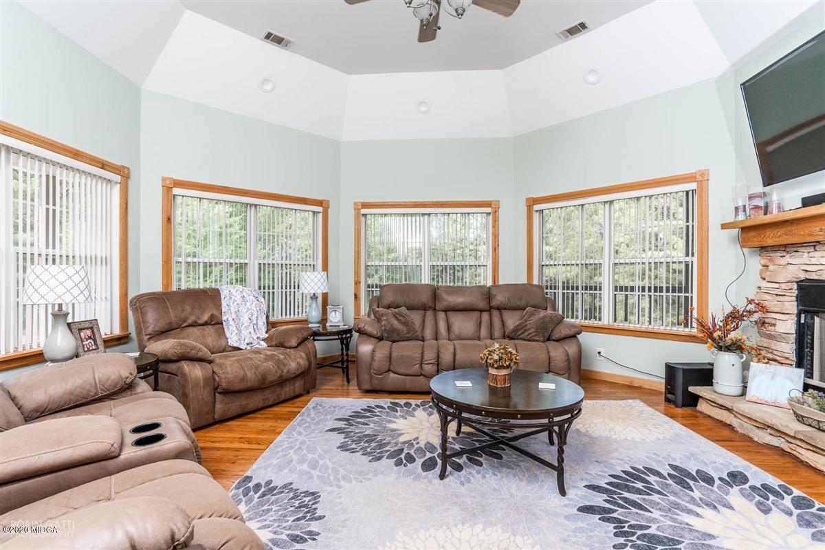 873 Blue Store Road Forsyth, GA 31029 - Photo 5 of 25 a living room with furniture a flat screen tv and a large window