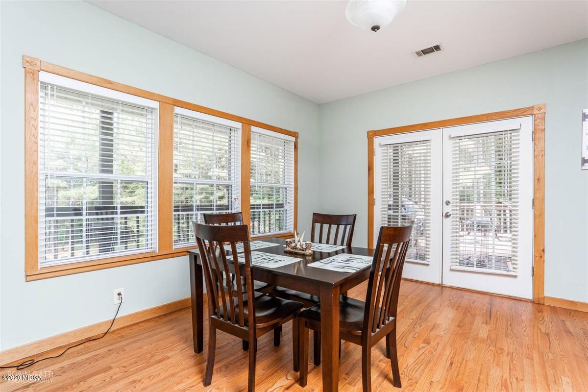 873 Blue Store Road Forsyth, GA 31029 - Photo 8 of 25 a view of a dining room with furniture large windows and wooden floor