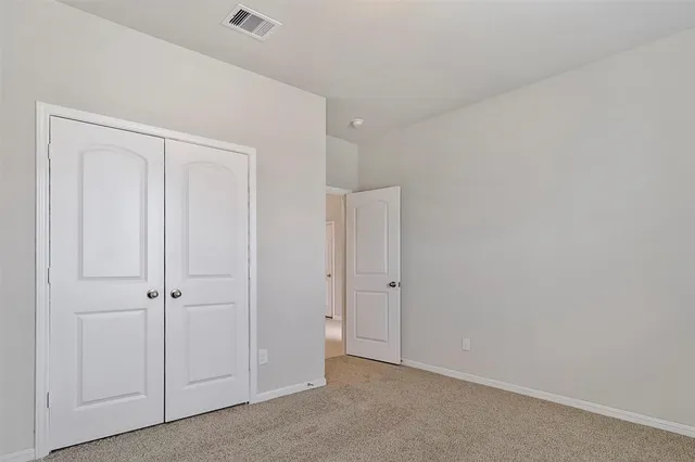 an empty room with closet area