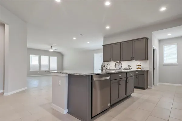 a kitchen with stainless steel appliances granite countertop a sink and cabinets