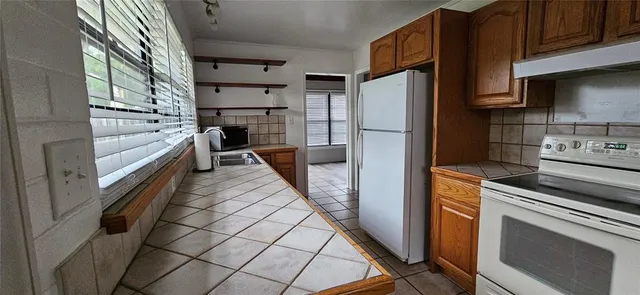 a kitchen with stainless steel appliances a refrigerator a stove and a sink