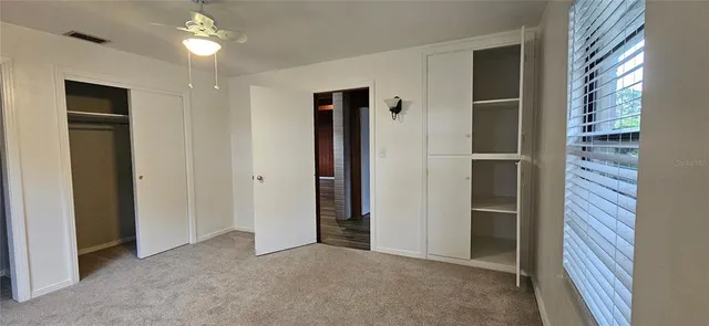 a view of empty room with closet and windows