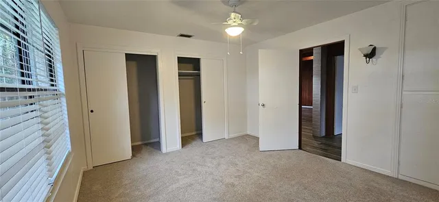 a bathroom with a granite countertop sink toilet and mirror