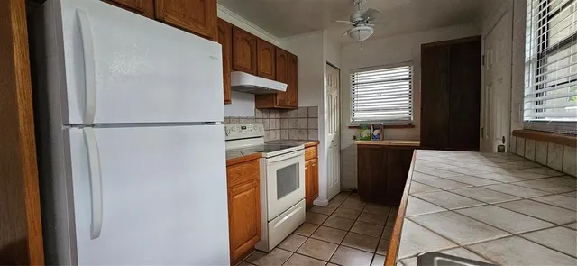 a kitchen with a refrigerator sink and stove
