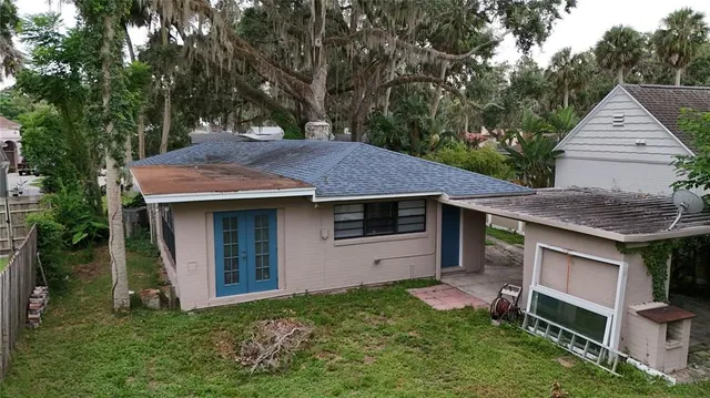 a view of backyard of house with green space
