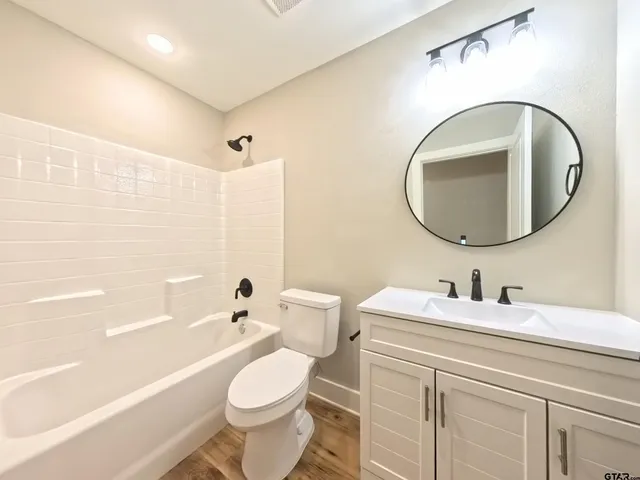 a bathroom with a toilet a sink and a mirror