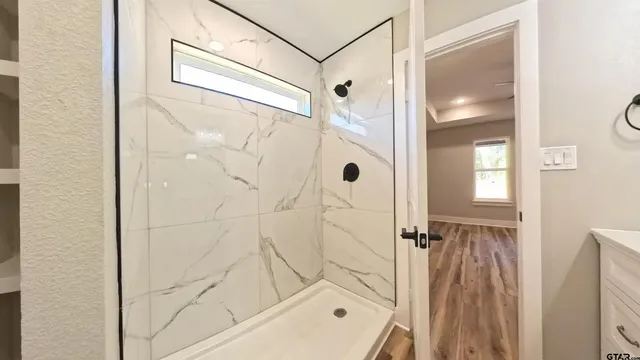 a bathroom with a glass shower door