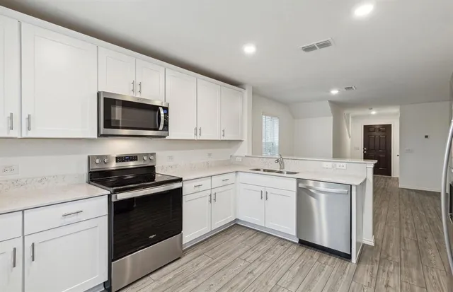 a kitchen with a sink stove and microwave
