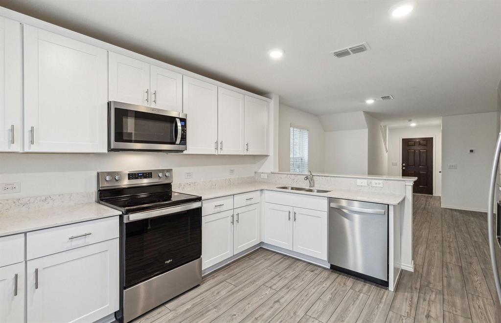 820 Lake Fletcher Road Princeton, TX 75407 - Photo 12 of 15 a kitchen with a sink stove and microwave